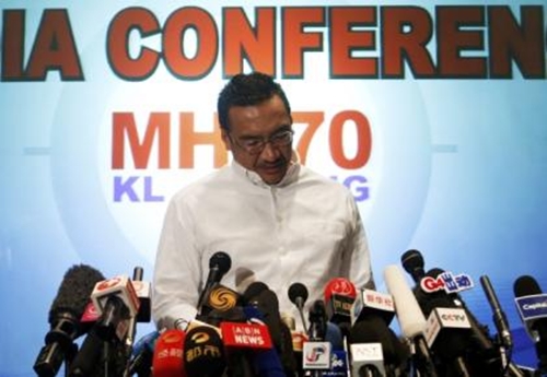 Malaysia's acting Transport Minister Hishammuddin Hussein reads a statement during a news conference about the missing Malaysia Airlines flight MH370, at Kuala Lumpur International Airport