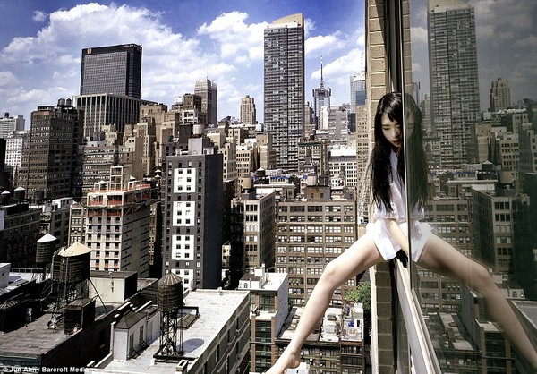 Vertigo: Artist Jun Ahn dangling a leg out of a New York skyscraper window. She has taken a series of pictures of herself on precarious perches